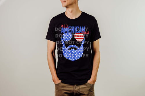 Man wearing a black shirt with a red, white, and blue graphic of a bearded face