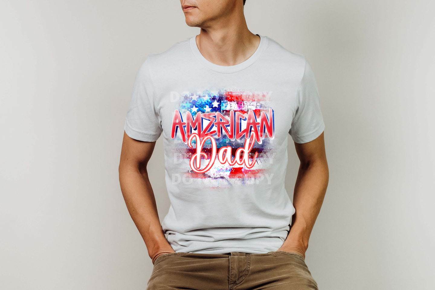 Man wearing a white shirt with a colorful “American Dad” design.