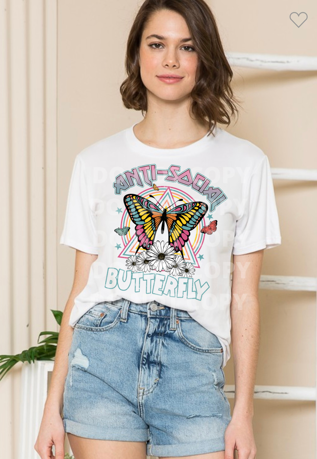 Woman wearing a white shirt with “Anti-Social Butterfly” graphic.